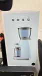 Smeg CGF01PBUS Pastel Blue 50S Retro Style Coffee Grinder (damaged Box). Fixed Price $250.00.